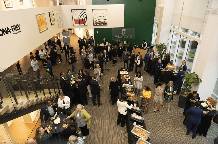 a lively group of people mingle in the reception area