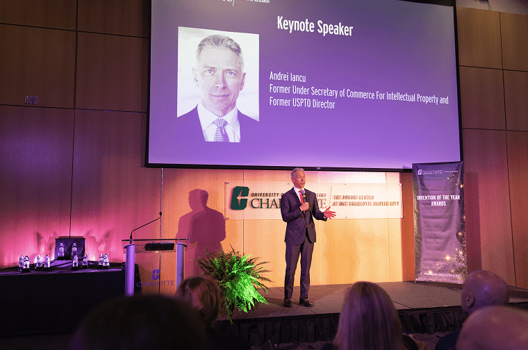 a man speaks onstage at in the auditorium at the dubois center