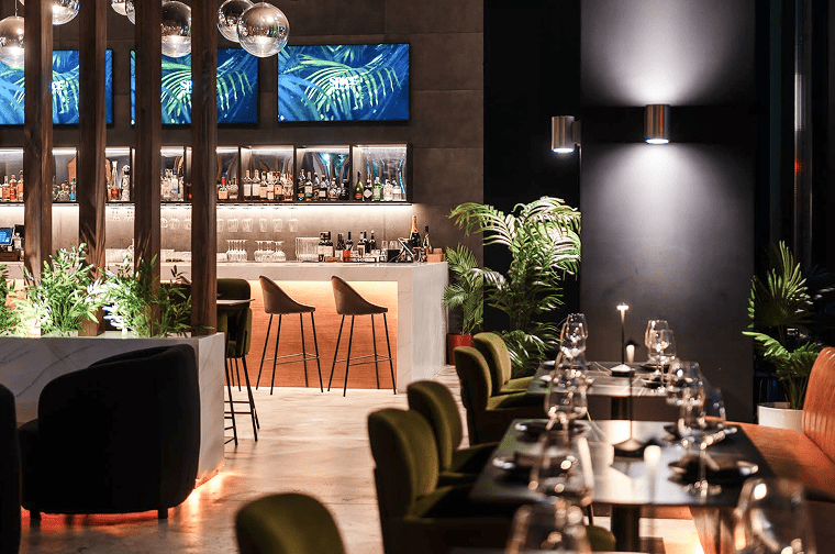 tables and chairs fill an upscale restaurant interior space
